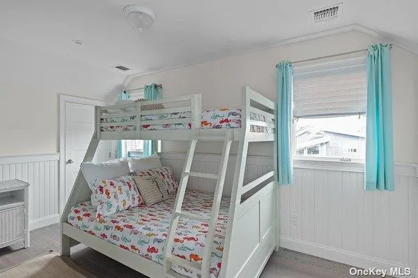 a view of a hallway with wooden floor and stairs