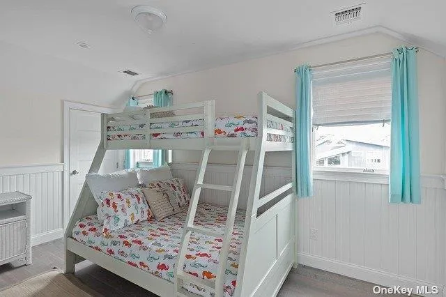 a view of a hallway with wooden floor and stairs