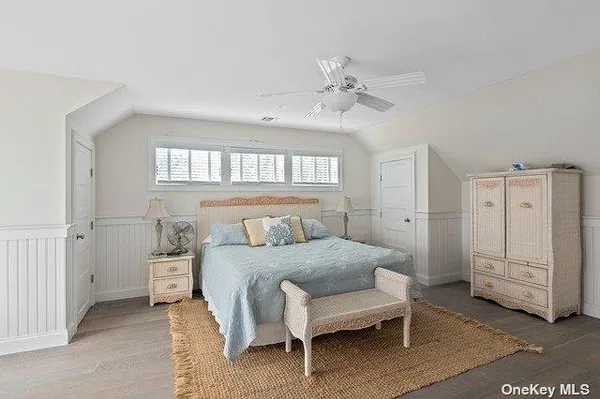 a bedroom with a bed a table and chair