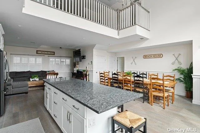 a kitchen with stainless steel appliances granite countertop a sink counter space and living room view