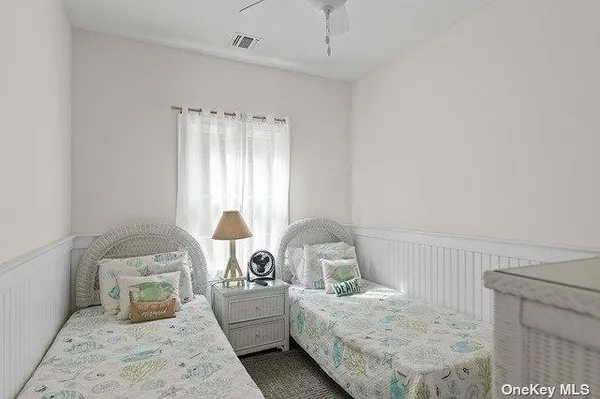 a bed sitting in a bedroom next to a window