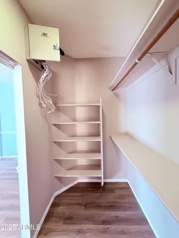 a view of walk in closet with empty racks