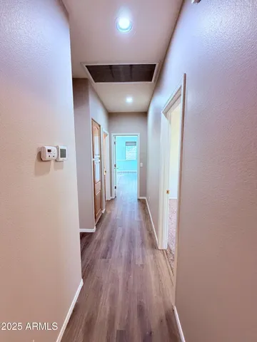 a view of hallway with wooden floor