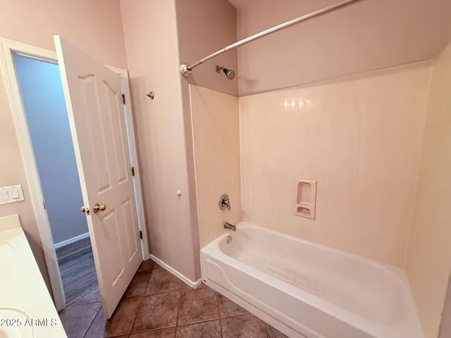 a bathroom with a tub a sink and a shower