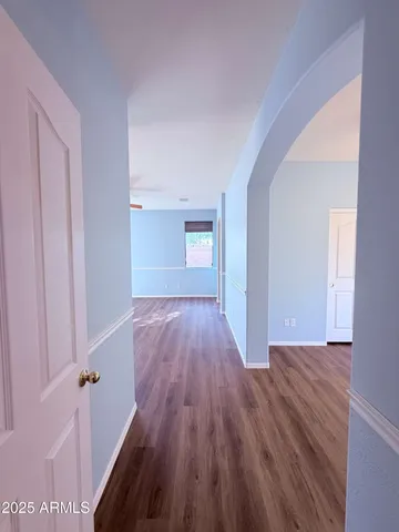 a view of a room with wooden floor and staircase