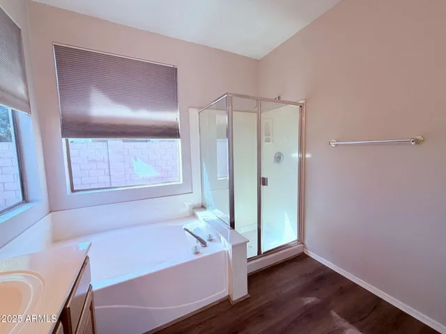 a bathroom with a tub shower and sink