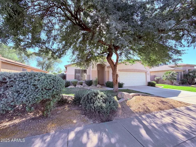 a view of backyard of house with outdoor seating and green space