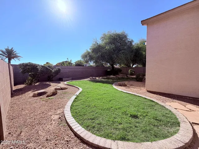 a view of a backyard with plants and a lake