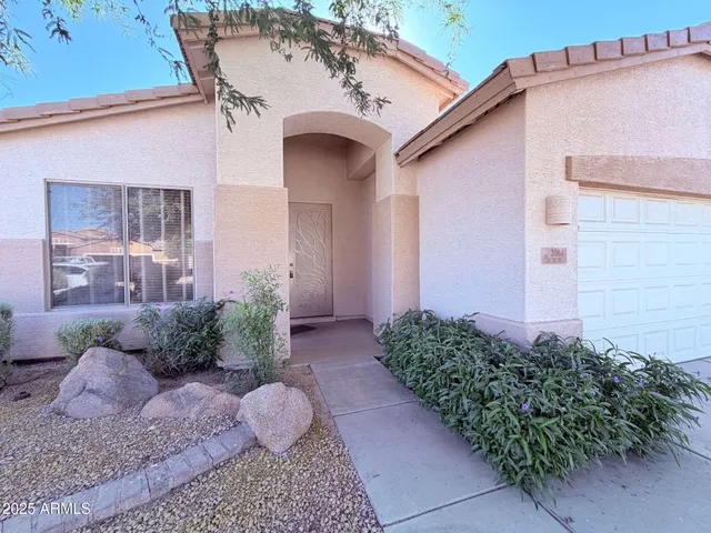 a view of a house with a yard and plants