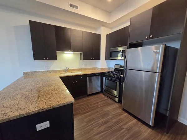 a kitchen with wooden cabinets sink and window
