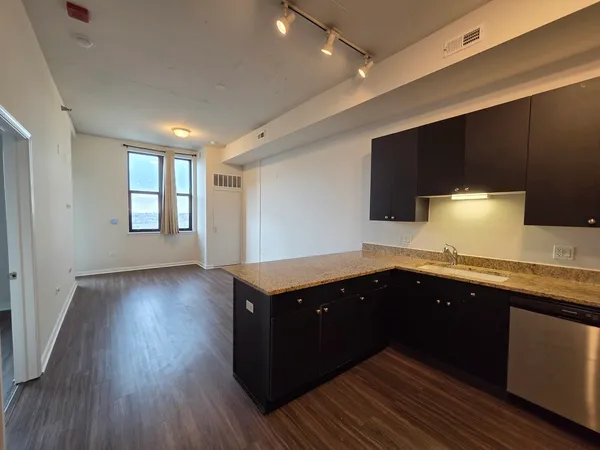 a kitchen with wooden cabinets and sink