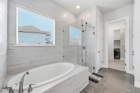 a bathroom with a tub a sink and a shower