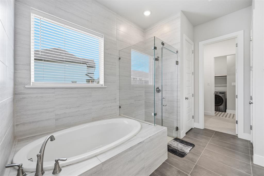 5805 Heatherwood Loop Sachse, TX 75048 - Photo 23 of 39 a bathroom with a tub a sink and a shower