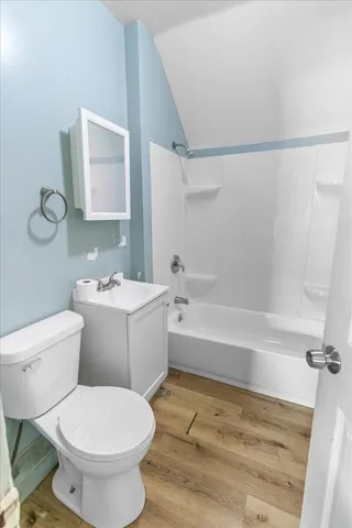 a bathroom with a toilet sink and shower