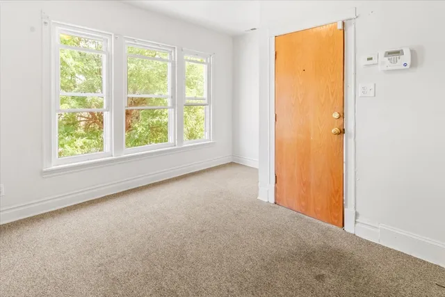 an empty room with windows and closet