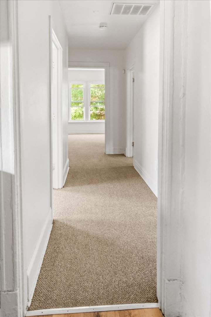 257 West 109th Place, Unit 2 Chicago, IL 60628 - Photo 4 of 11 an empty room with windows