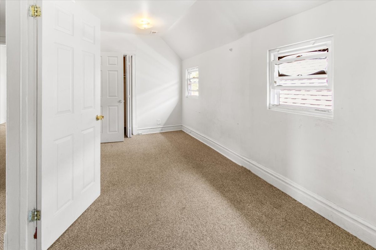 257 West 109th Place, Unit 2 Chicago, IL 60628 - Photo 6 of 11 an empty room with windows and closet