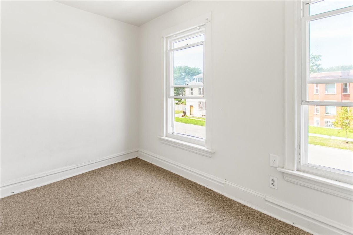 257 West 109th Place, Unit 2 Chicago, IL 60628 - Photo 7 of 11 an empty room with a window