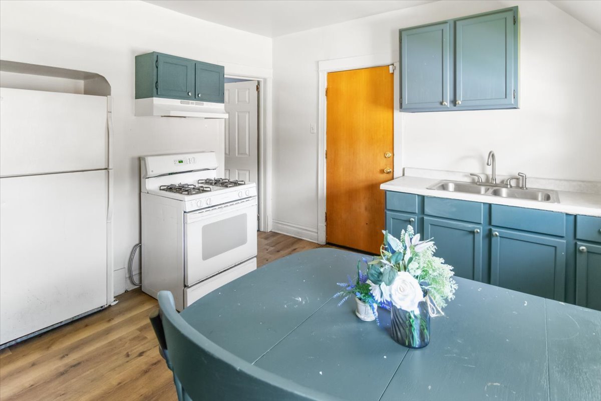 257 West 109th Place, Unit 2 Chicago, IL 60628 - Photo 9 of 11 a kitchen with stainless steel appliances granite countertop a sink a stove a refrigerator a washer and dryer