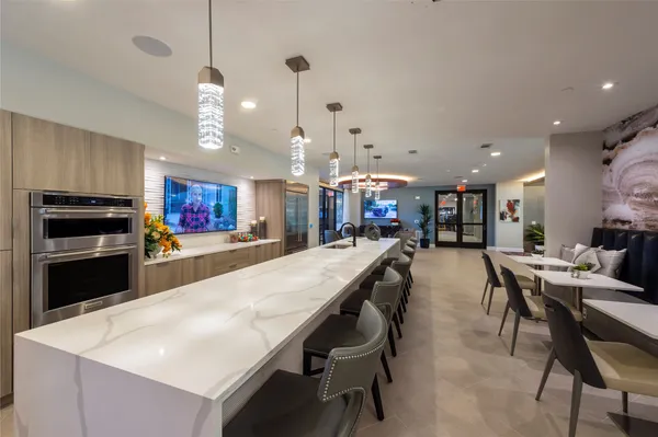 a large kitchen with a table and chairs