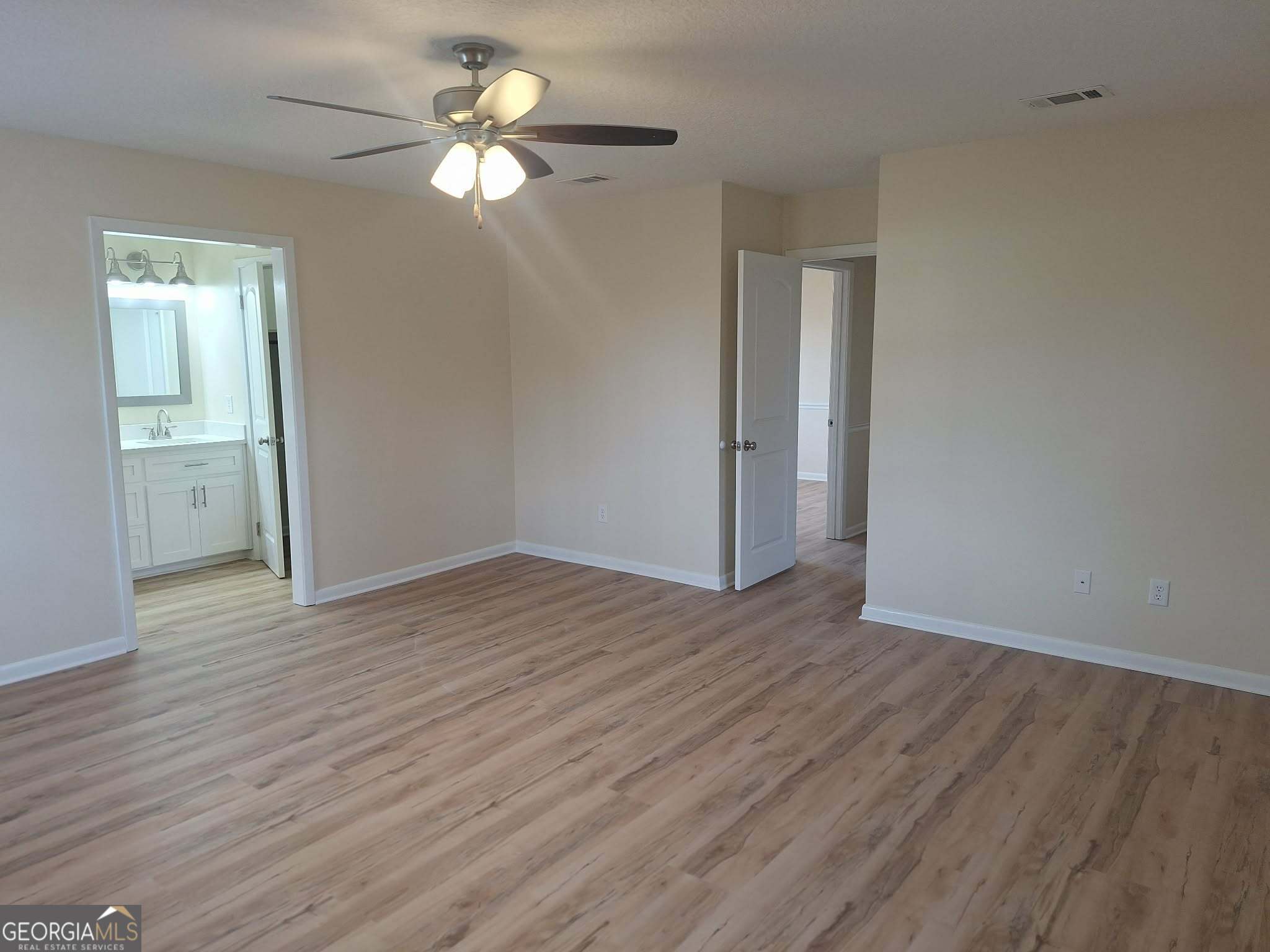 249 Satilla Church Road Baxley, GA 31513 - Photo 15 of 26 a view of a room with wooden floor and a ceiling fan