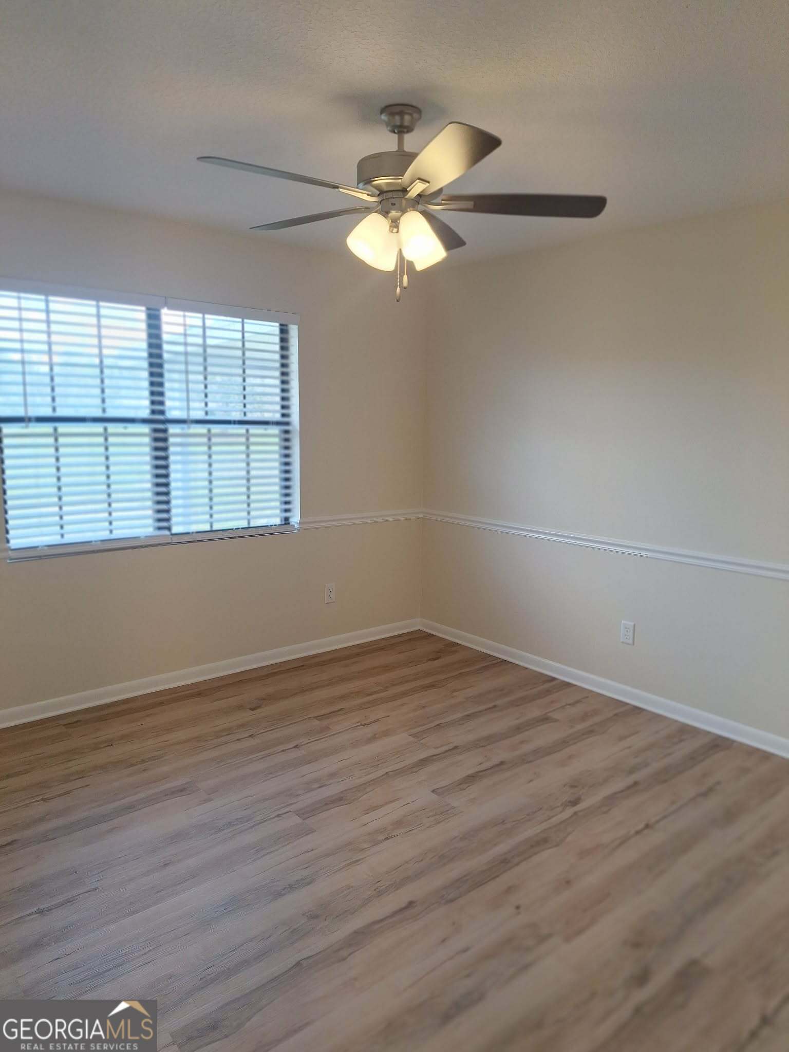 249 Satilla Church Road Baxley, GA 31513 - Photo 19 of 26 a view of an empty room with wooden floor and a window