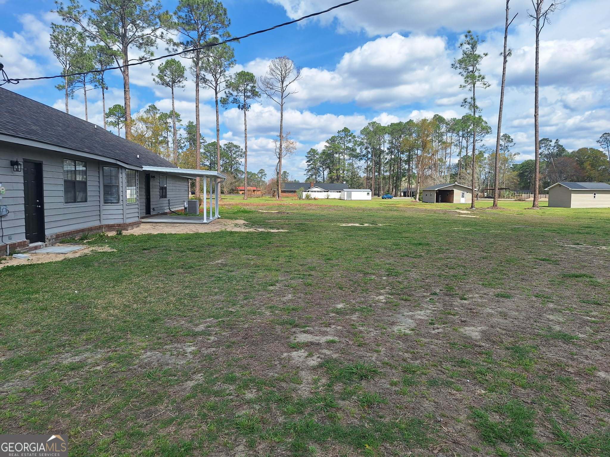 249 Satilla Church Road Baxley, GA 31513 - Photo 23 of 26 a view of a house with a big yard and a large tree