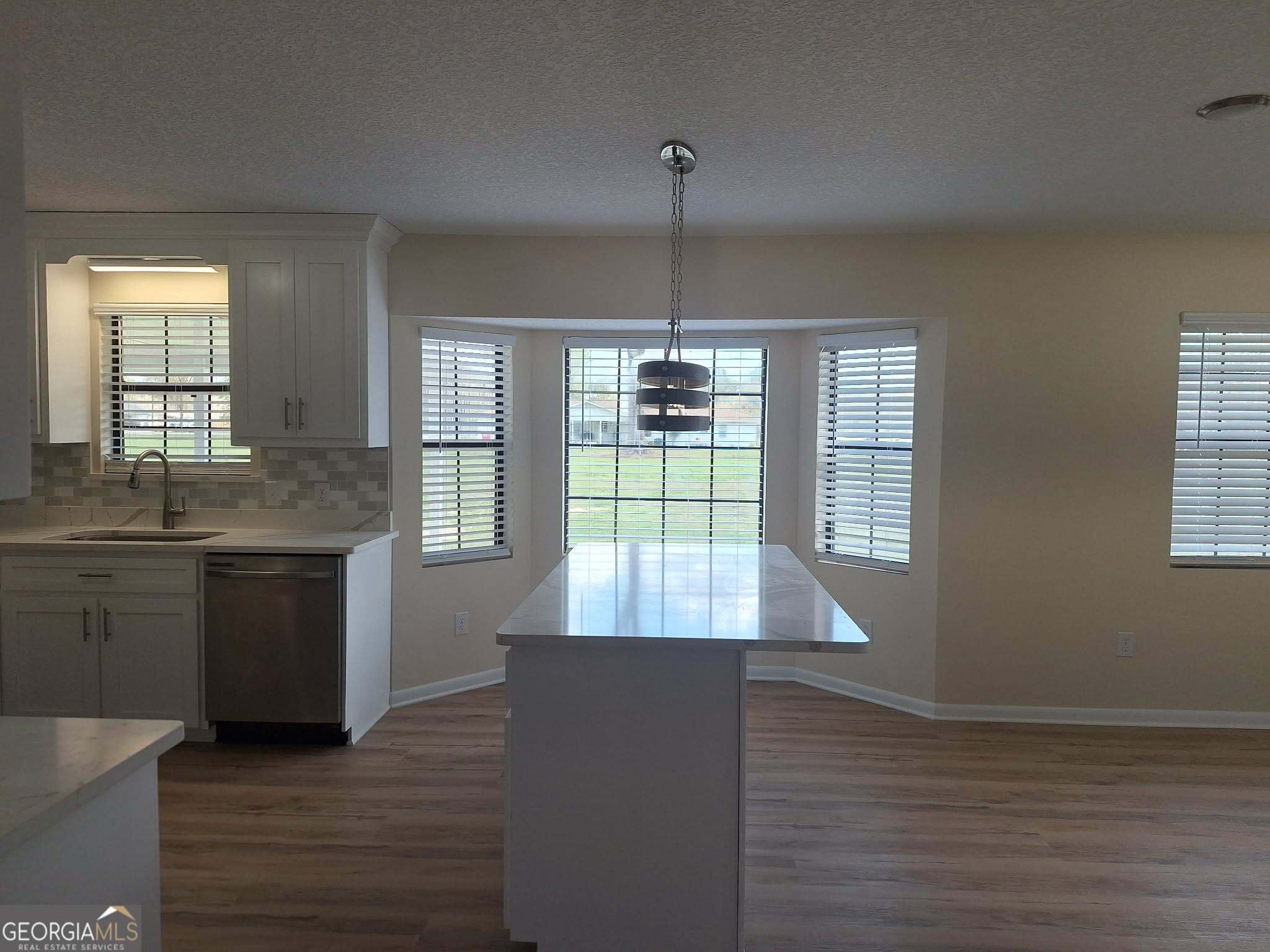 249 Satilla Church Road Baxley, GA 31513 - Photo 7 of 26 a view of kitchen with granite countertop window and wooden floor