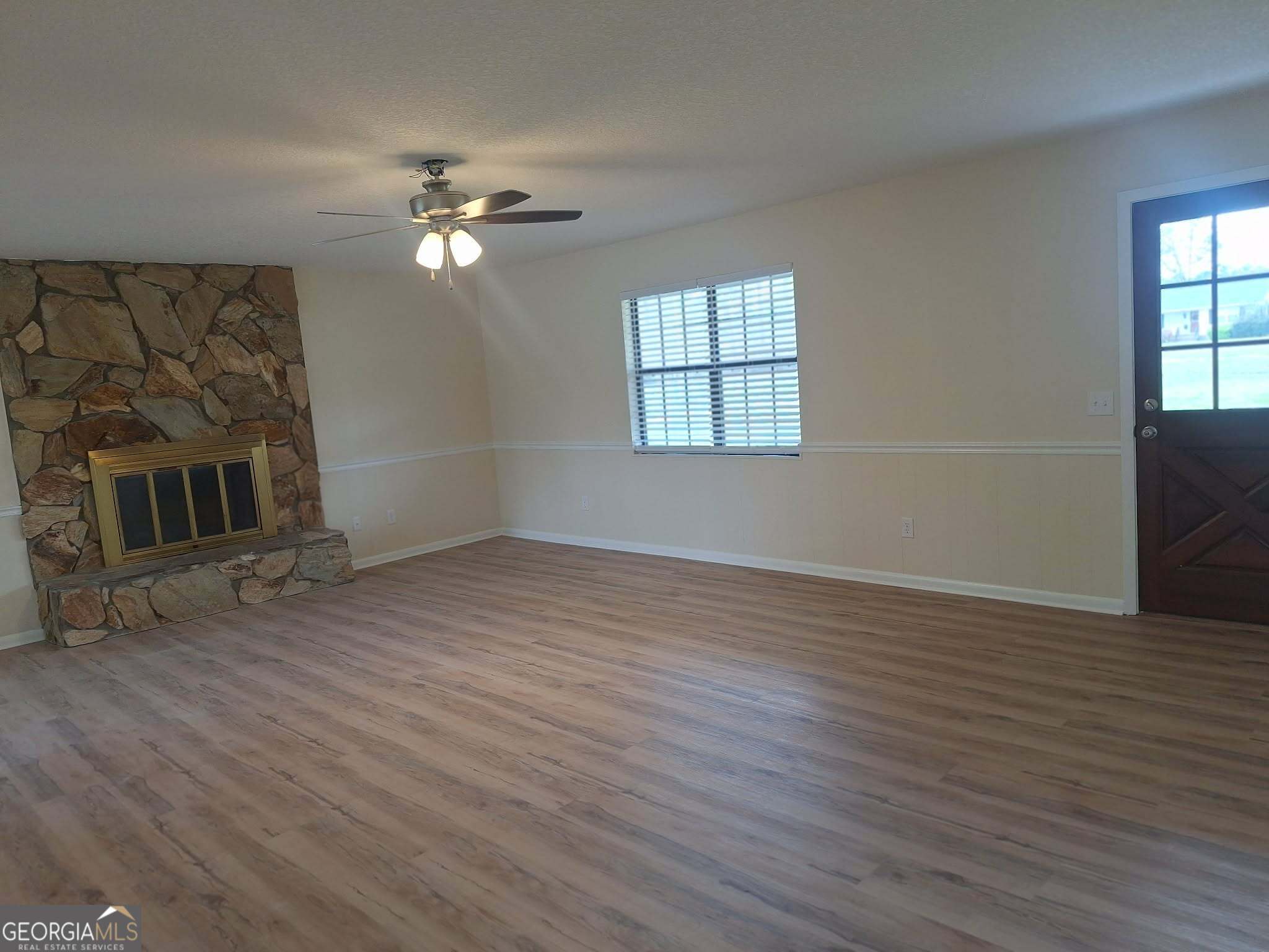 249 Satilla Church Road Baxley, GA 31513 - Photo 8 of 26 a view of livingroom with hardwood floor and ceiling fan