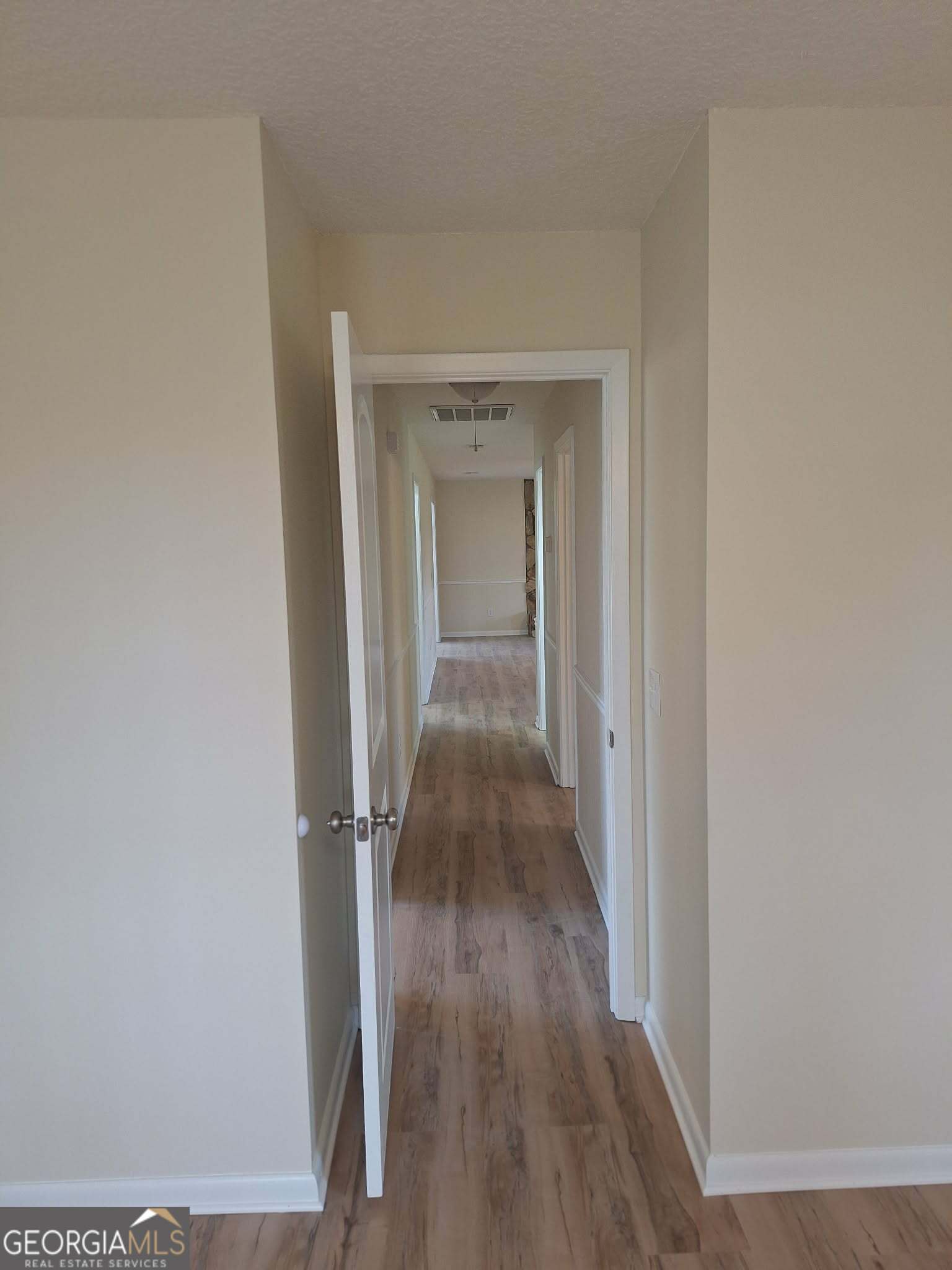 249 Satilla Church Road Baxley, GA 31513 - Photo 10 of 26 a view of a hallway with wooden floor
