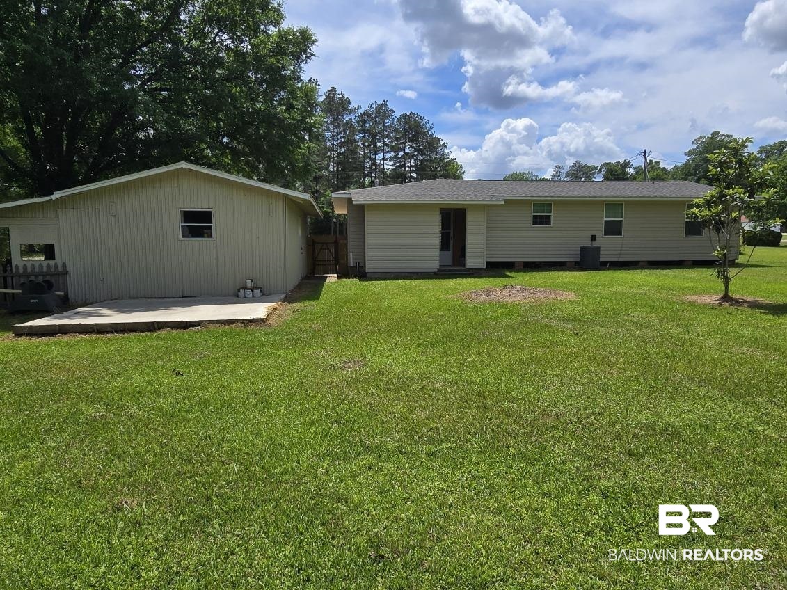 2534 Foshee Road Brewton, AL 36426 - Photo 14 of 16 Back of property featuring a yard, cooling unit, and a patio