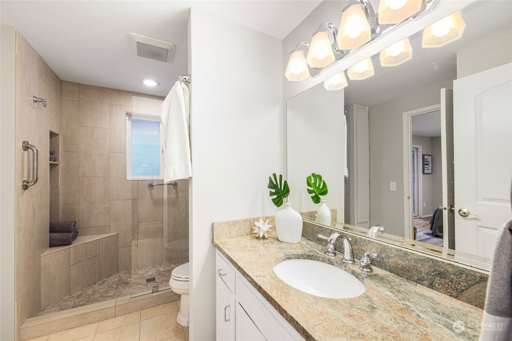 10810 9th Drive Southeast Everett, WA 98208 - Photo 12 of 26 a bathroom with a granite countertop sink a toilet a mirror and shower