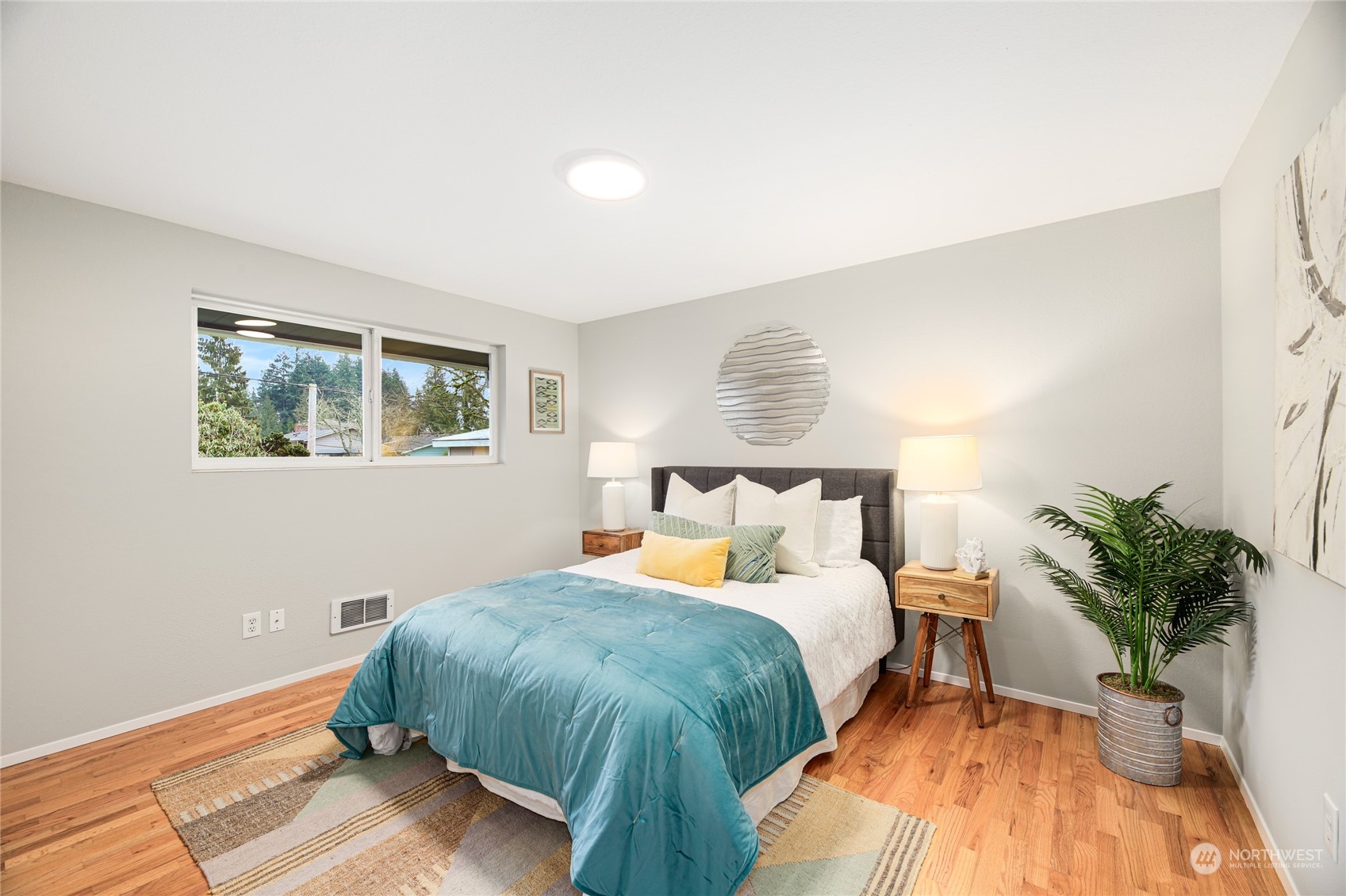 10810 9th Drive Southeast Everett, WA 98208 - Photo 14 of 26 a bedroom with a large bed and a potted plant