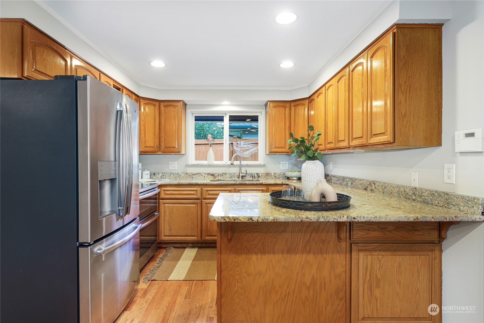 10810 9th Drive Southeast Everett, WA 98208 - Photo 6 of 26 a kitchen with stainless steel appliances granite countertop a sink and a refrigerator