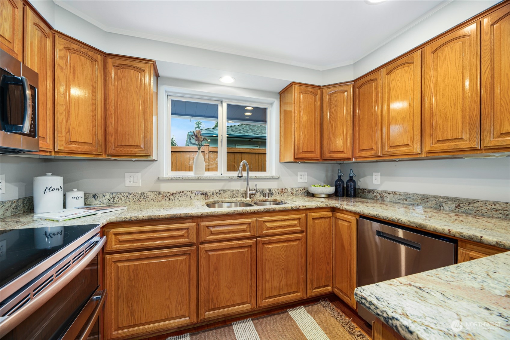 10810 9th Drive Southeast Everett, WA 98208 - Photo 7 of 26 a kitchen with stainless steel appliances granite countertop wooden cabinets a sink and a dishwasher