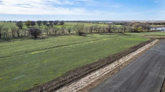 a view of a field with an ocean
