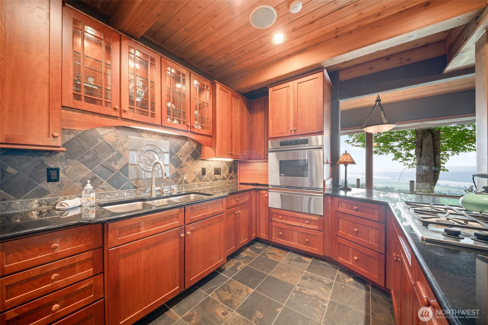 813 Varsity Road Kalama, WA 98625 - Photo 13 of 40 a kitchen with stainless steel appliances granite countertop a stove sink and cabinets