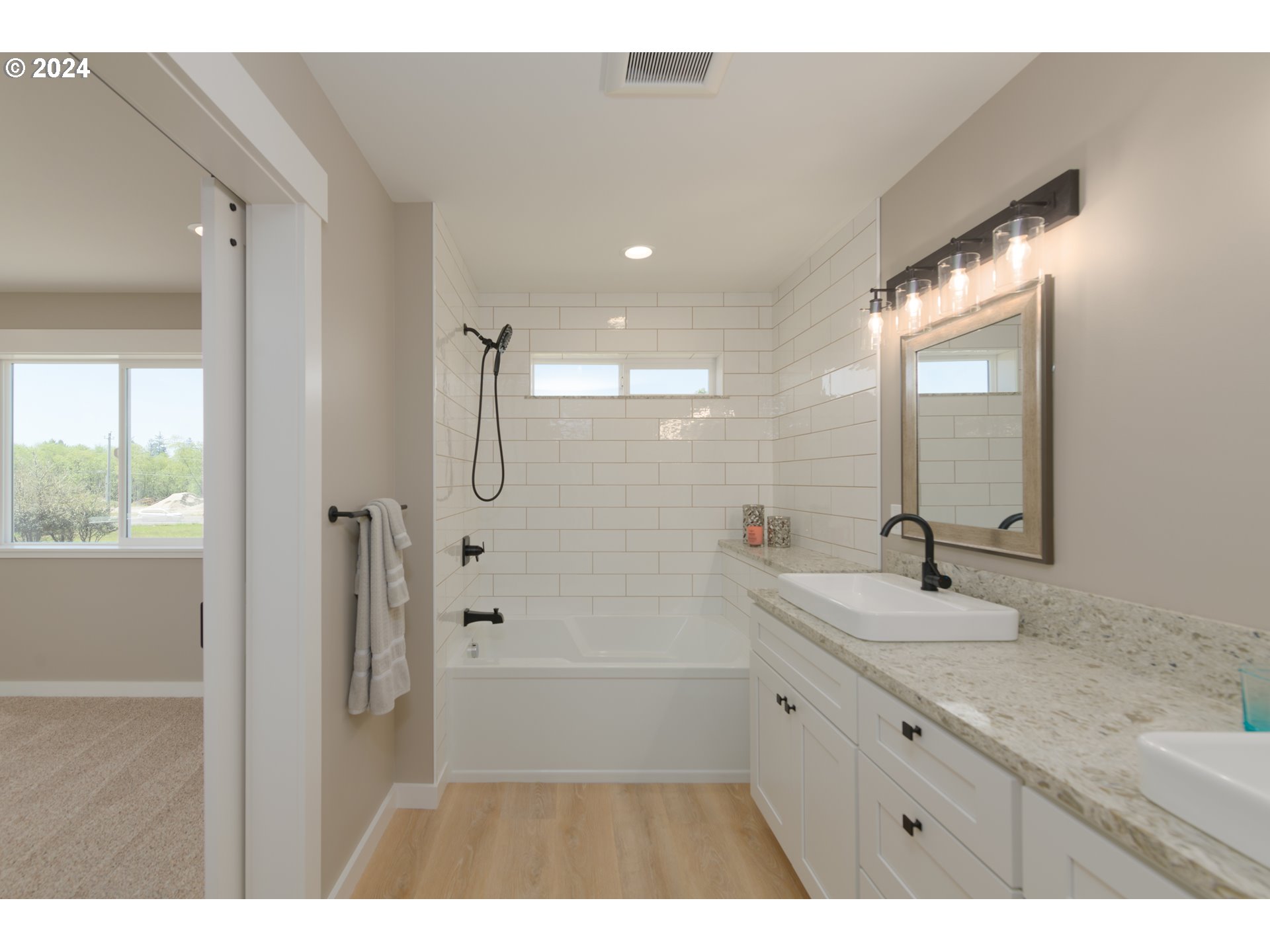 1324 Sea Ridge Lane Gearhart, OR 97138 - Photo 19 of 21 a bathroom with a granite countertop sink mirror and a bathtub