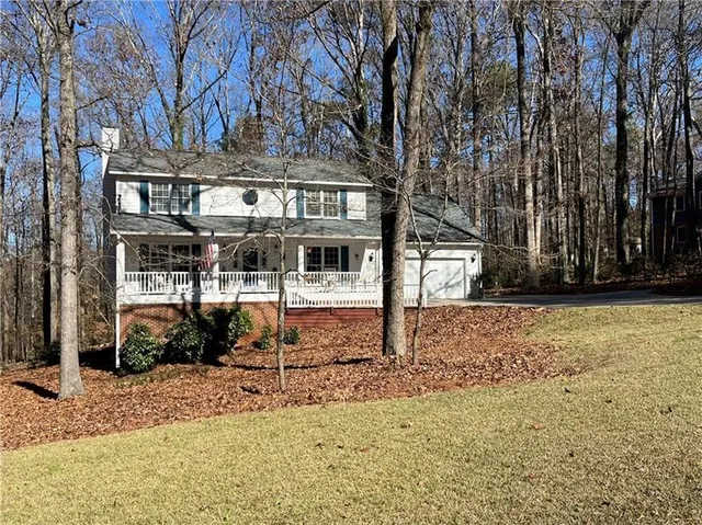 a view of a house with large trees