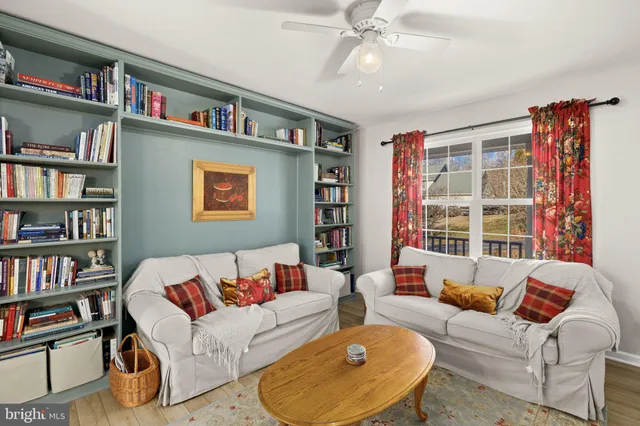 a living room with furniture and a book shelf