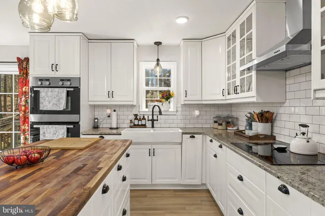 a kitchen with stainless steel appliances granite countertop a sink and cabinets