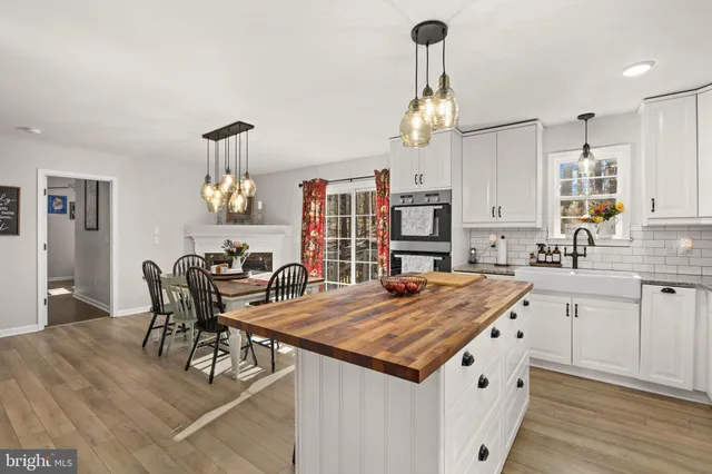 a view of a dining room with furniture and chandelier