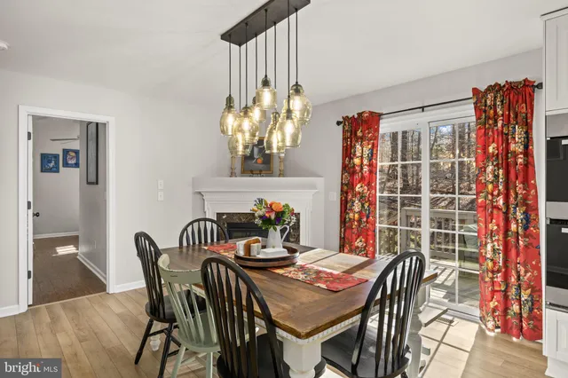 a view of a dining room with furniture and chandelier
