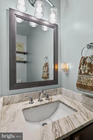 a bathroom with a sink a toilet and mirror