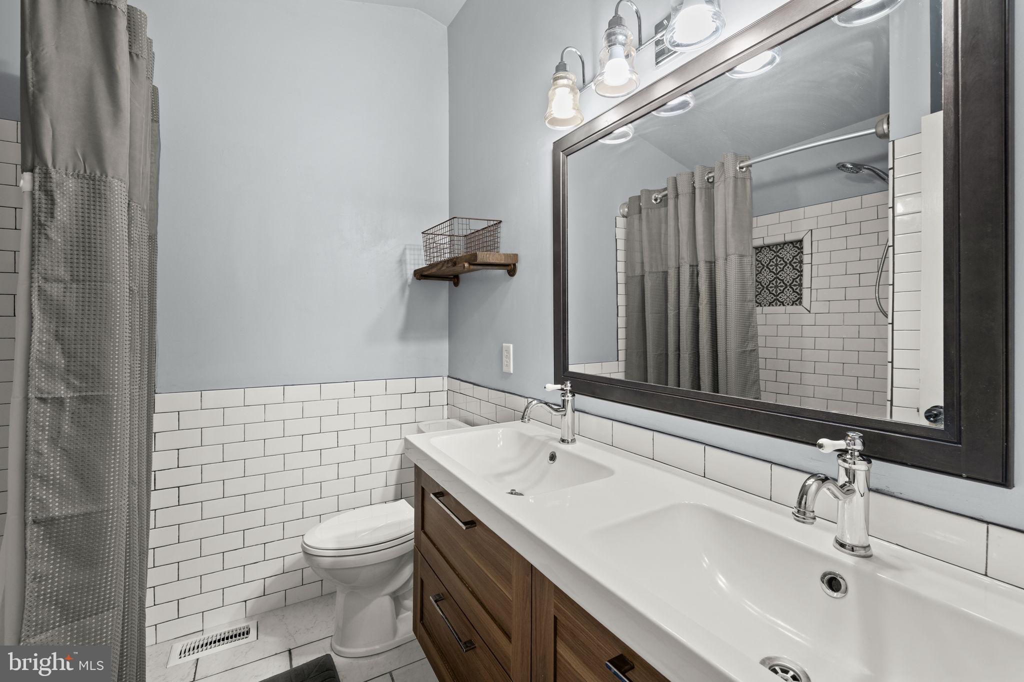 6463 Wheeler Drive King George, VA 22485 - Photo 22 of 57 a bathroom with a sink a toilet and mirror