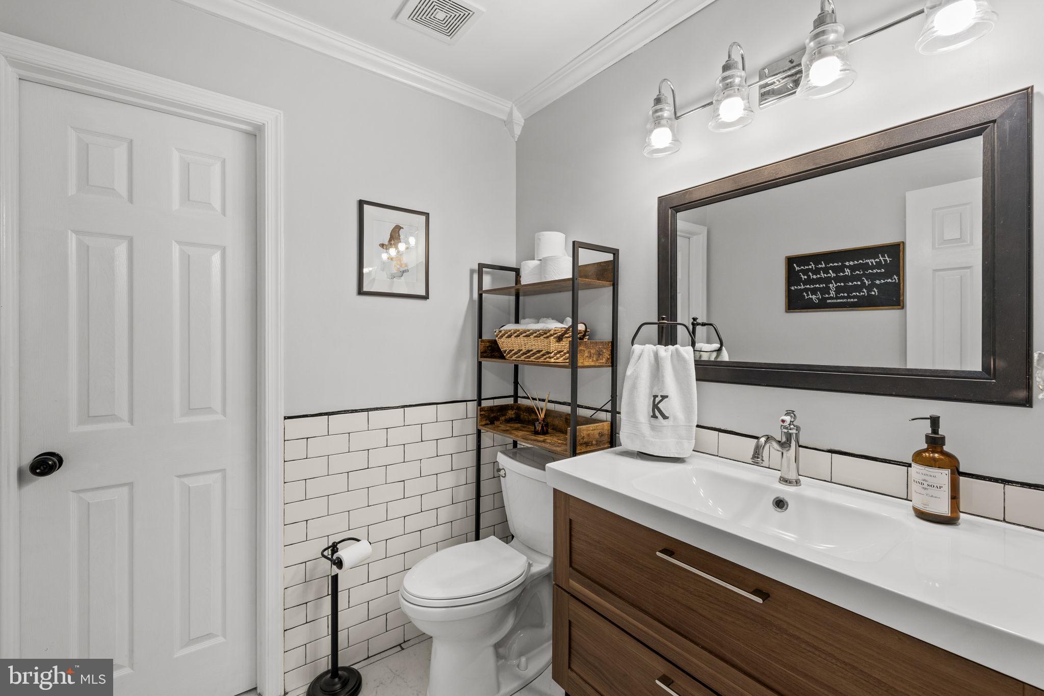 6463 Wheeler Drive King George, VA 22485 - Photo 25 of 57 a bathroom with a toilet sink and mirror