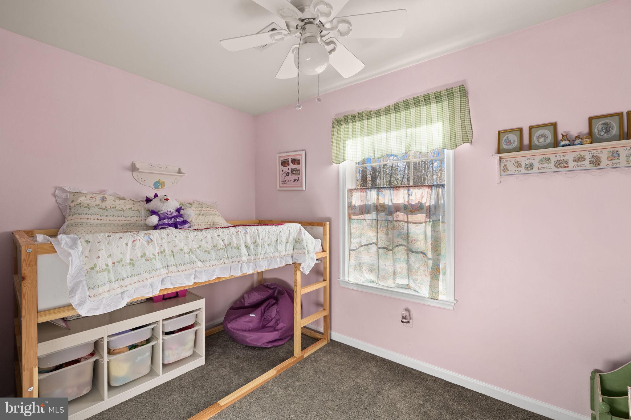 6463 Wheeler Drive King George, VA 22485 - Photo 29 of 57 a bedroom with a bed and a chandelier