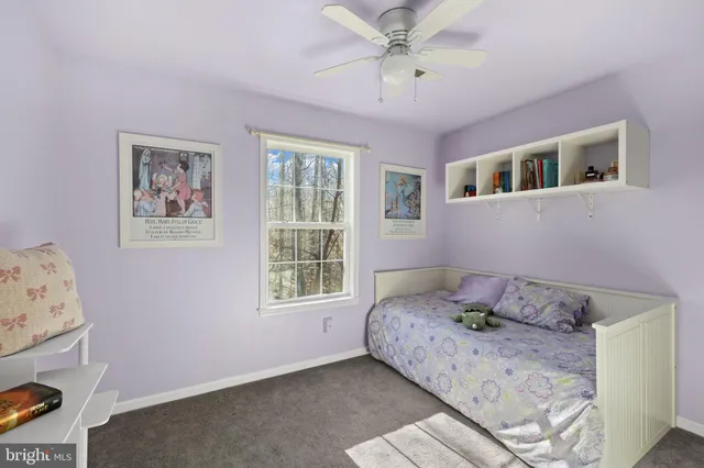 a living room with furniture a flat screen tv and a window