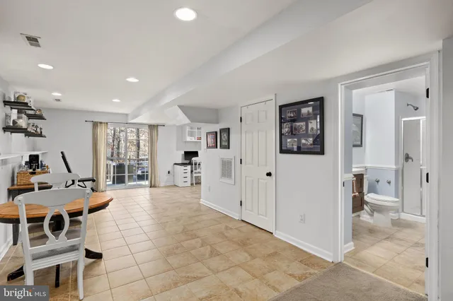 a living room with furniture a dining table and a large window