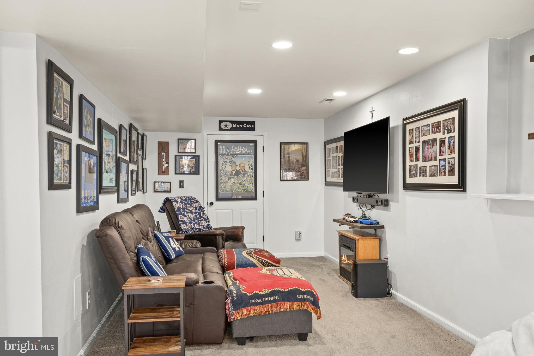 6463 Wheeler Drive King George, VA 22485 - Photo 34 of 57 a living room with furniture a flat screen tv and a window
